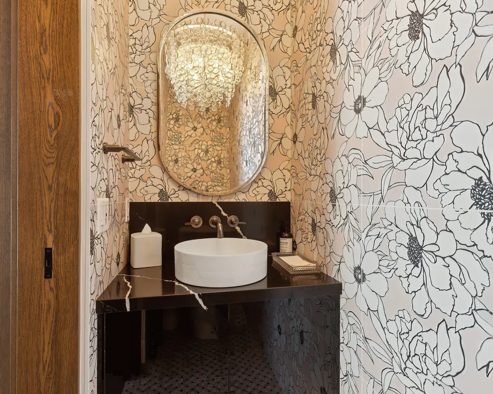 Powder room with floral wallpaper and a vessel sink in a Park City home managed by Life Elevated