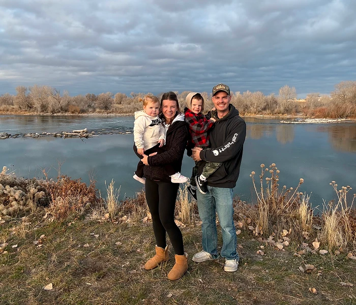 Chris Scurti and his family beside a river