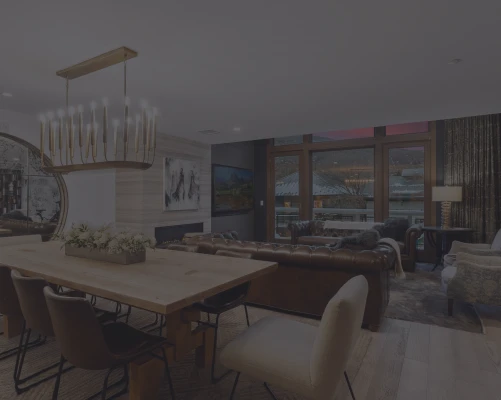 Dining table and leather sofas in the great room of a luxury Life Elevated rental